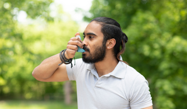 Man uses asthma inhaler 